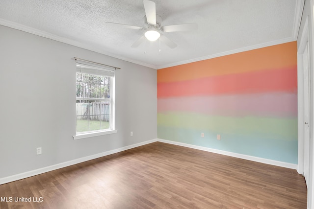 unfurnished room with a textured ceiling, wood finished floors, baseboards, and ceiling fan