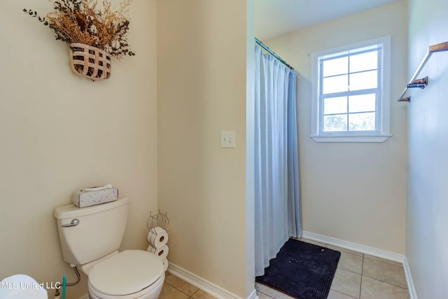 bathroom featuring toilet and tile patterned floors