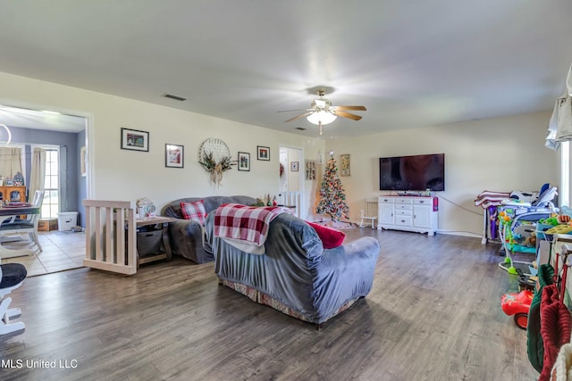 living room featuring hardwood / wood-style floors and ceiling fan