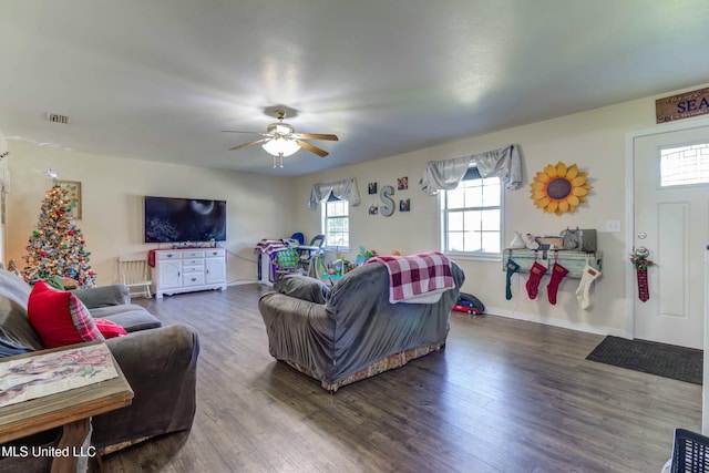 living room featuring dark hardwood / wood-style floors, a wealth of natural light, and ceiling fan