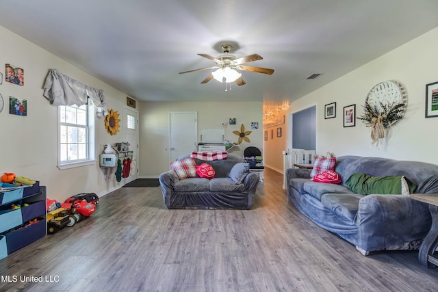 living room featuring hardwood / wood-style floors and ceiling fan