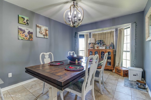 dining space with light tile patterned floors and a notable chandelier