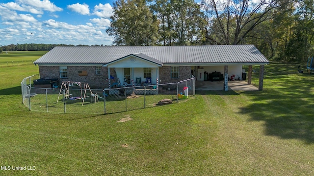 back of house with a lawn