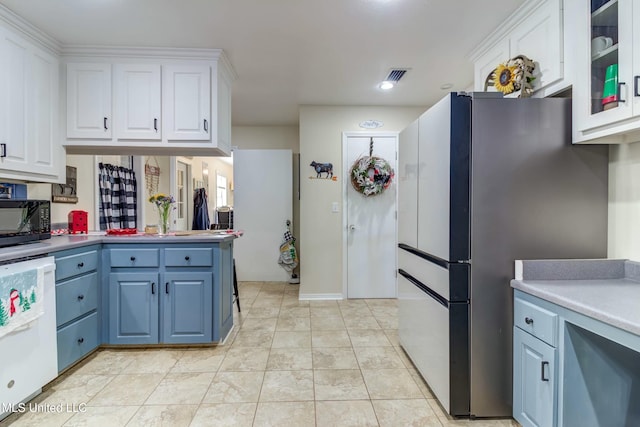 kitchen featuring dishwasher, stainless steel fridge, white cabinetry, and blue cabinets