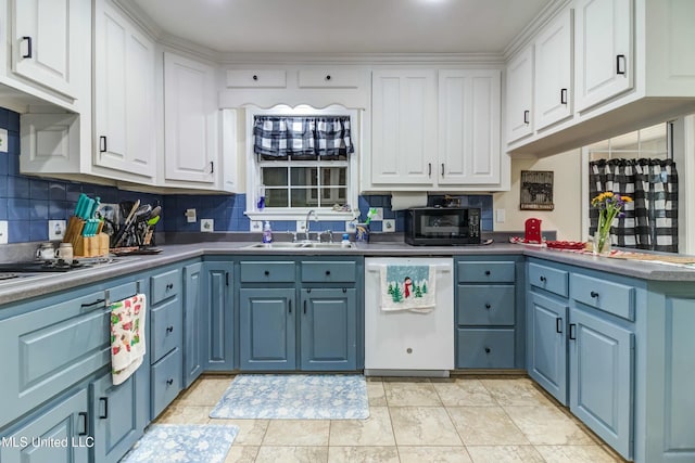 kitchen featuring white cabinets, blue cabinetry, dishwasher, and sink