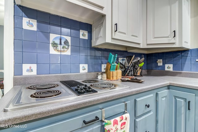 kitchen featuring backsplash, stainless steel electric cooktop, and white cabinetry