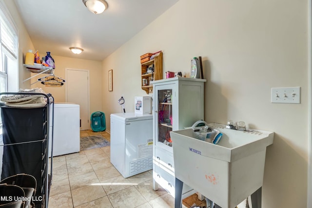 laundry area with light tile patterned floors and sink