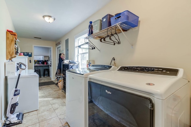 washroom featuring light tile patterned floors and separate washer and dryer