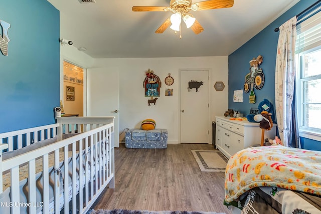 bedroom featuring hardwood / wood-style floors and ceiling fan