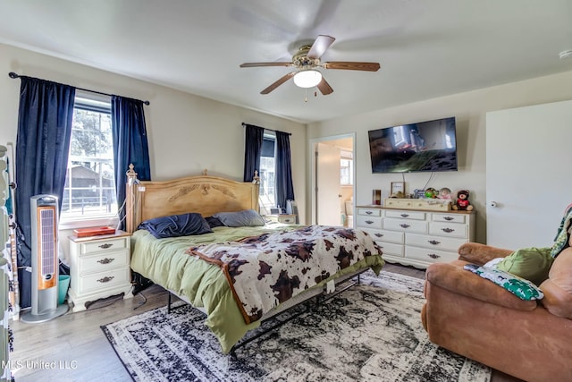 bedroom with ceiling fan and light wood-type flooring