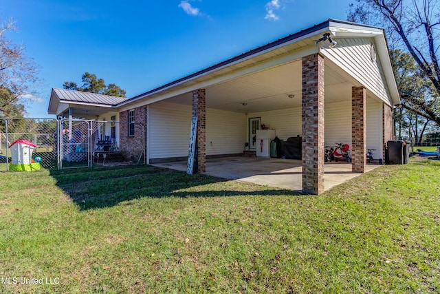 view of home's exterior with a yard and a carport