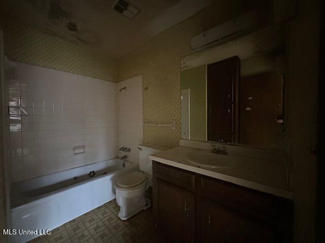 full bathroom featuring vanity, toilet, and tiled shower / bath combo