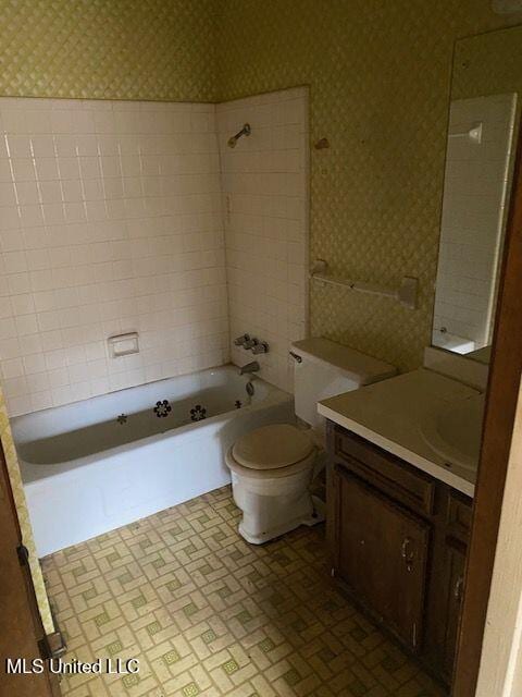 full bathroom with vanity, toilet, and tiled shower / bath