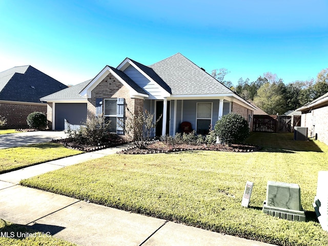 view of front of property with cooling unit, a front yard, and a garage