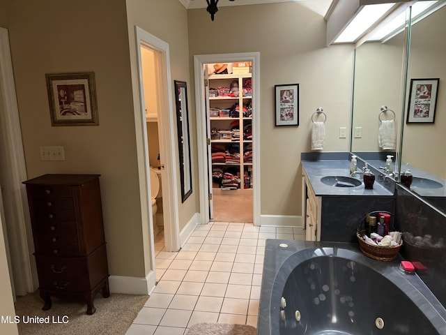 420 Fox Bay Dr, Brandon, MS 39047 - bathroom featuring double vanity, tile patterned flooring, toilet, and a whirlpool tub