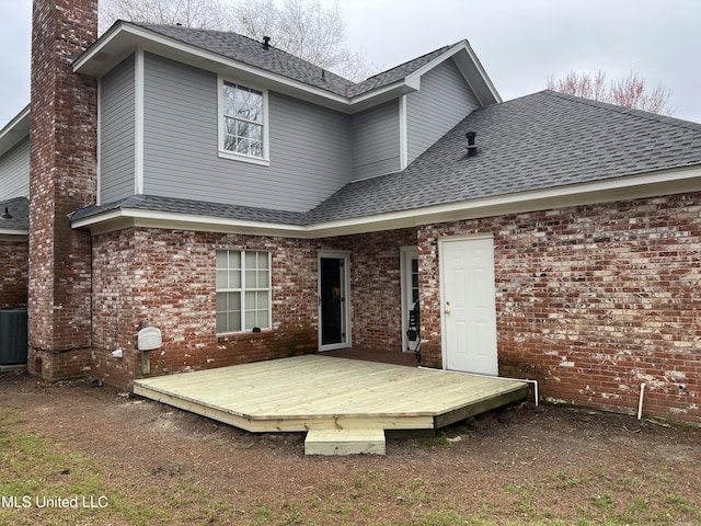 420 Fox Bay Dr, Brandon, MS 39047 - rear view of property featuring a shingled roof, a wooden deck, a chimney, brick siding, and central AC