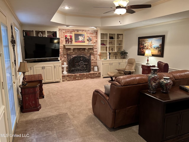 420 Fox Bay Dr, Brandon, MS 39047 - carpeted living room with a tray ceiling, ornamental molding, ceiling fan, built in shelves, and a brick fireplace