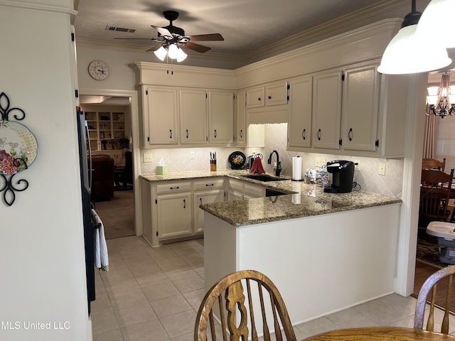 420 Fox Bay Dr, Brandon, MS 39047 - kitchen featuring a sink, light tile patterned floors, ceiling fan, decorative backsplash, and ornamental molding