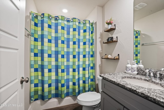 bathroom featuring toilet, visible vents, shower / bath combination with curtain, and vanity