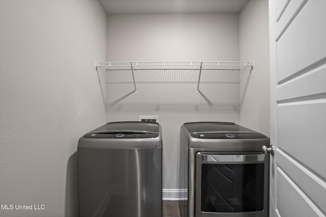 clothes washing area with laundry area and washing machine and clothes dryer