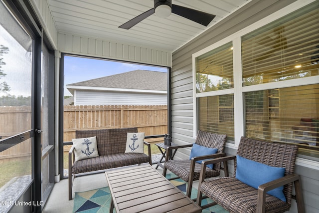 sunroom / solarium featuring ceiling fan and a wealth of natural light