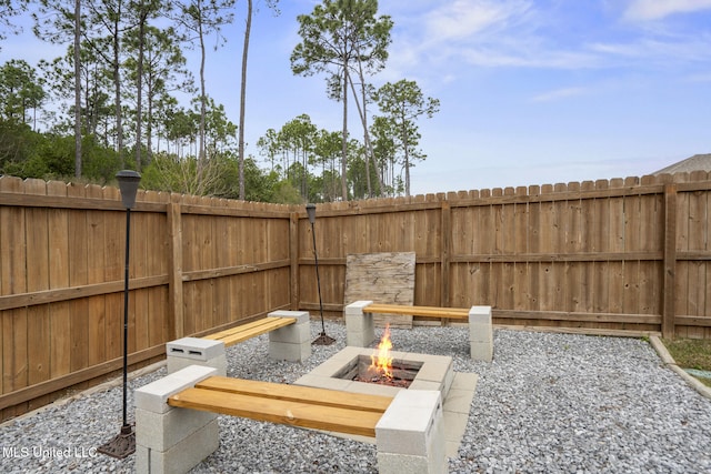 view of patio / terrace with an outdoor fire pit and fence