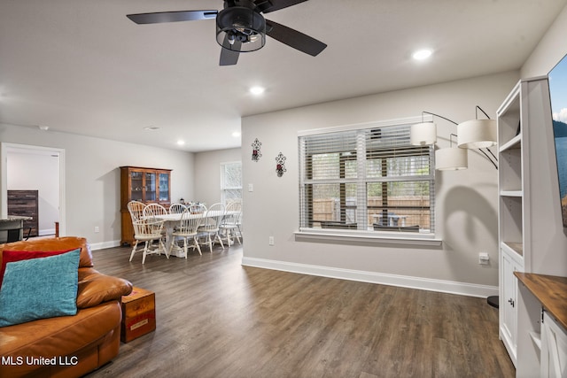 dining area featuring baseboards, dark wood finished floors, and recessed lighting