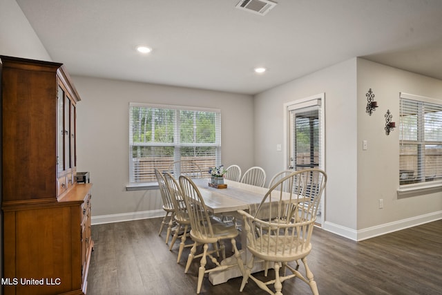 dining space featuring plenty of natural light, dark wood finished floors, and visible vents