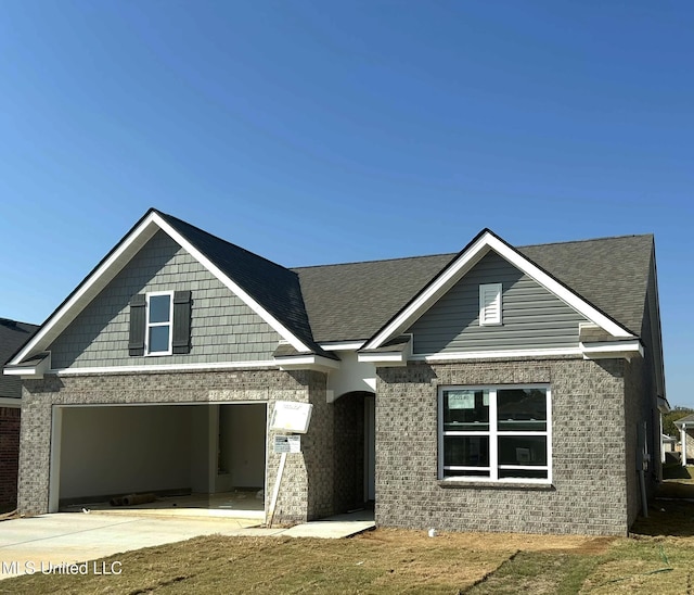 38 Silo Ln, Byhalia, MS 38611 - view of front of home featuring driveway, brick siding, a garage, and roof with shingles