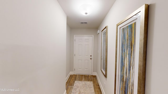 hall with hardwood / wood-style floors