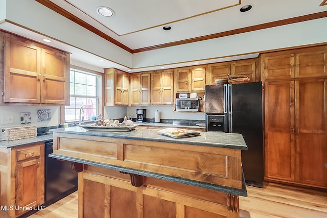 kitchen featuring light wood-type flooring, black fridge with ice dispenser, a center island, and ornamental molding