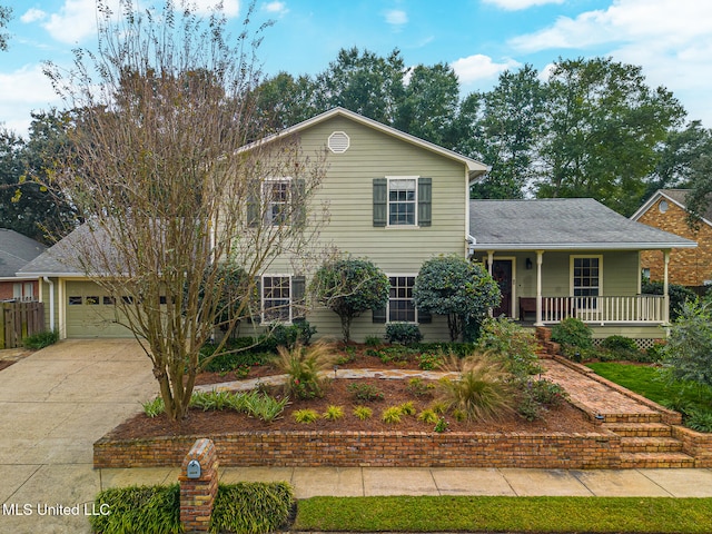 view of front of property with a garage and covered porch