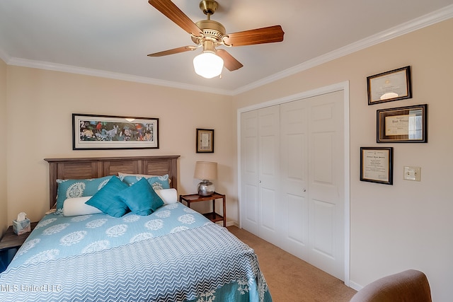 carpeted bedroom featuring a closet, ceiling fan, and ornamental molding