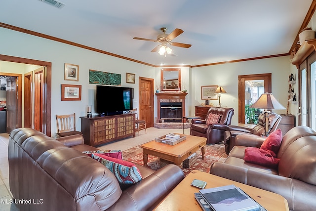 tiled living room with ceiling fan and ornamental molding