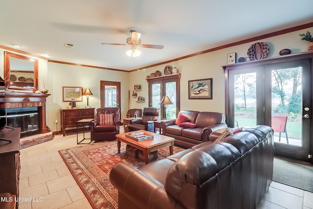 living room with ceiling fan, french doors, a brick fireplace, crown molding, and light tile patterned flooring