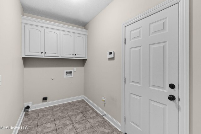 clothes washing area featuring hookup for a gas dryer, baseboards, washer hookup, and cabinet space