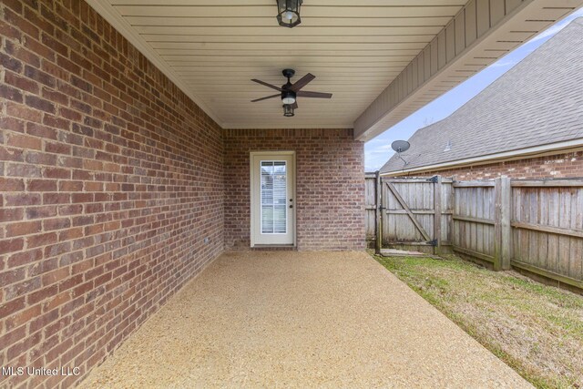 view of patio featuring ceiling fan, a gate, and fence