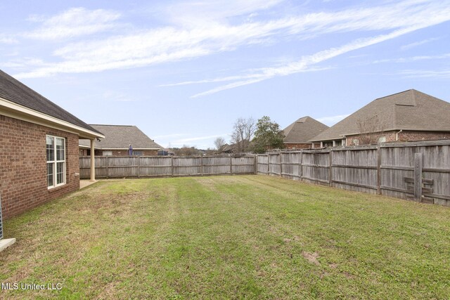 view of yard with a fenced backyard