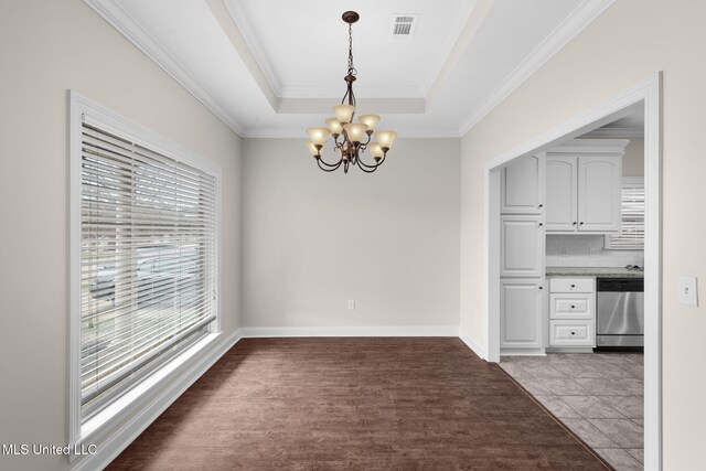 unfurnished dining area featuring crown molding, visible vents, a chandelier, and a tray ceiling