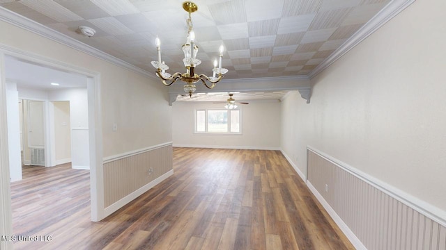 unfurnished room with visible vents, ornamental molding, wood finished floors, and wainscoting