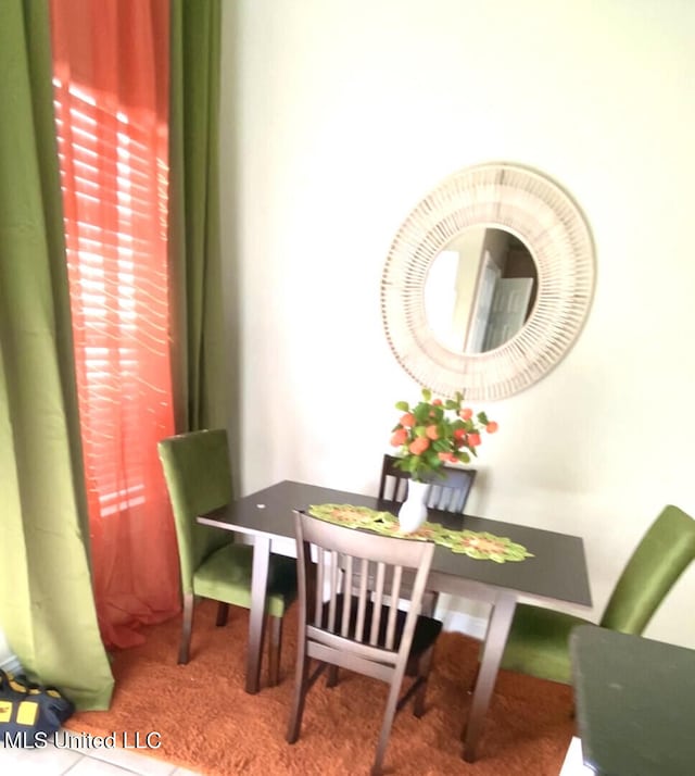 dining area featuring carpet