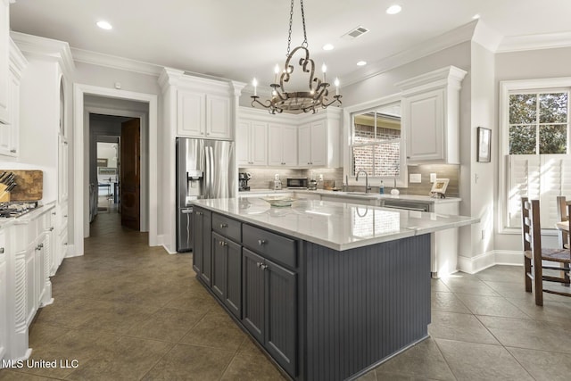 kitchen with stainless steel appliances, visible vents, white cabinets, ornamental molding, and gray cabinets