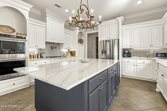 kitchen with stainless steel appliances, gray cabinets, white cabinetry, and crown molding