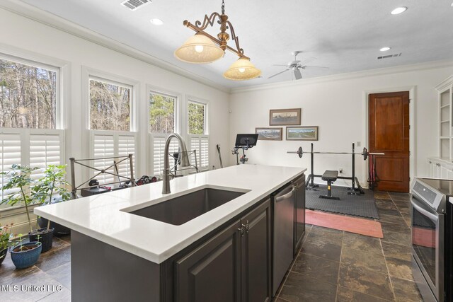 kitchen featuring stainless steel appliances, a sink, and crown molding