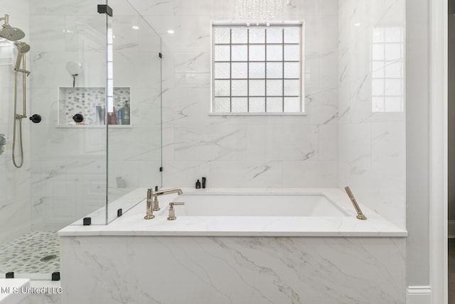 full bath with a garden tub and a marble finish shower