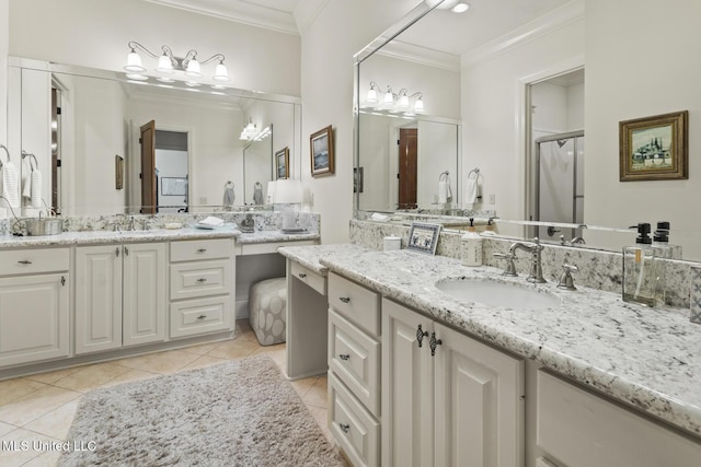 bathroom with tile patterned floors, two vanities, a sink, and crown molding