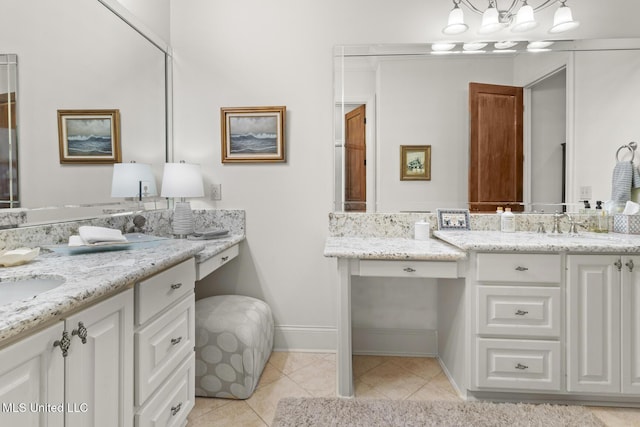 full bathroom featuring baseboards, tile patterned flooring, two vanities, and a notable chandelier