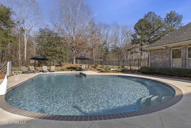 view of swimming pool featuring a patio, fence, and a fenced in pool