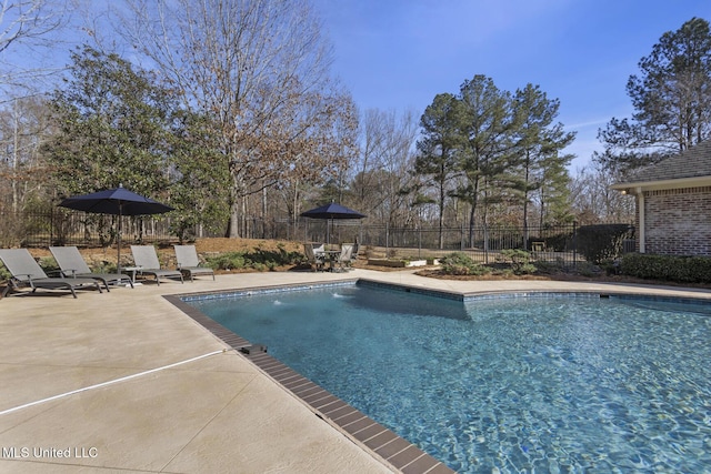 view of swimming pool with a patio area, fence, and a fenced in pool