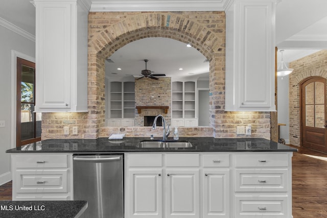 kitchen featuring crown molding, stainless steel dishwasher, sink, and white cabinets